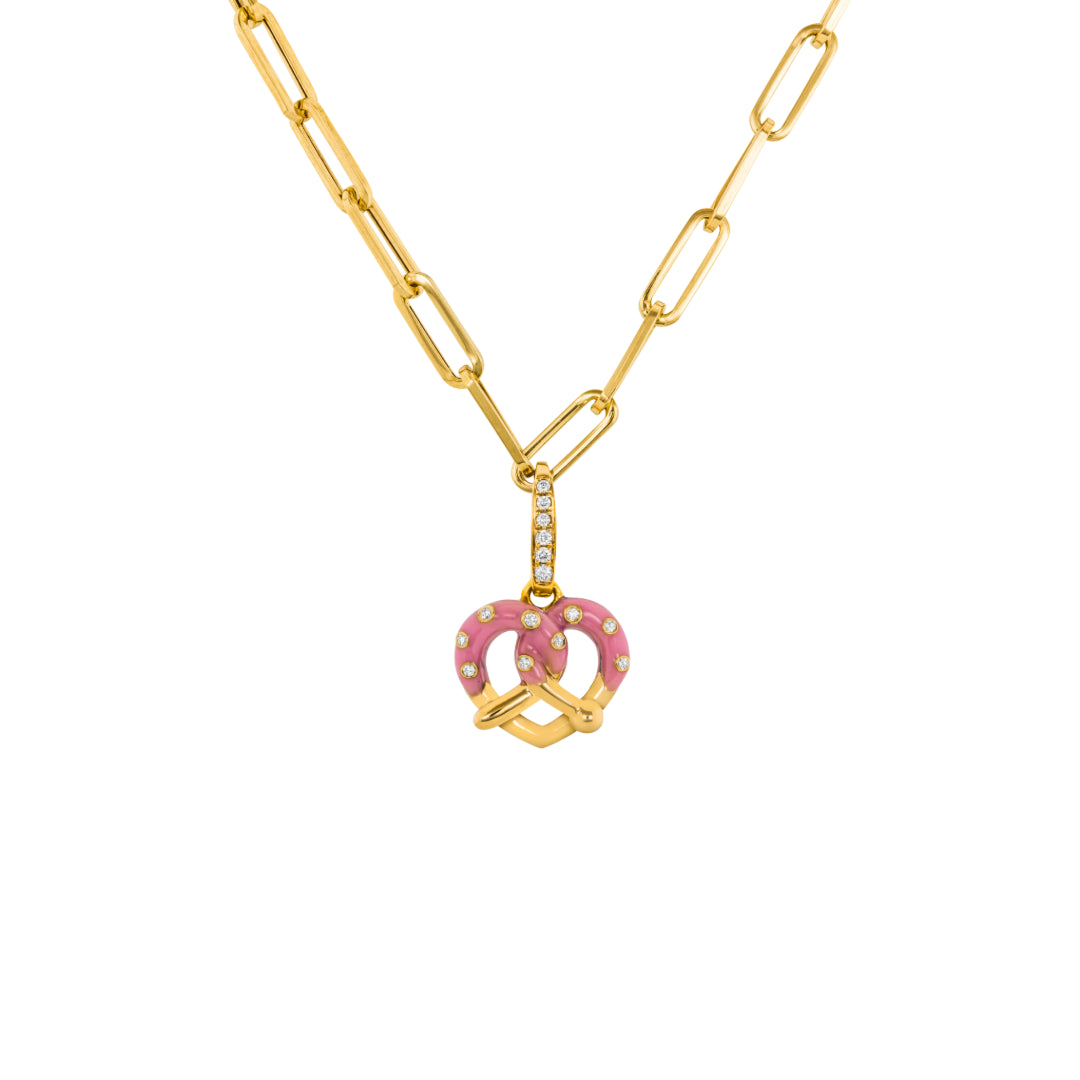 Yellow gold necklace with a pink Pretzel Charm on white background