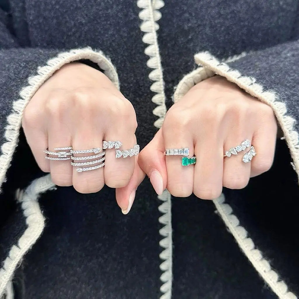 Stack rings on two hands wearing multiple coil rings