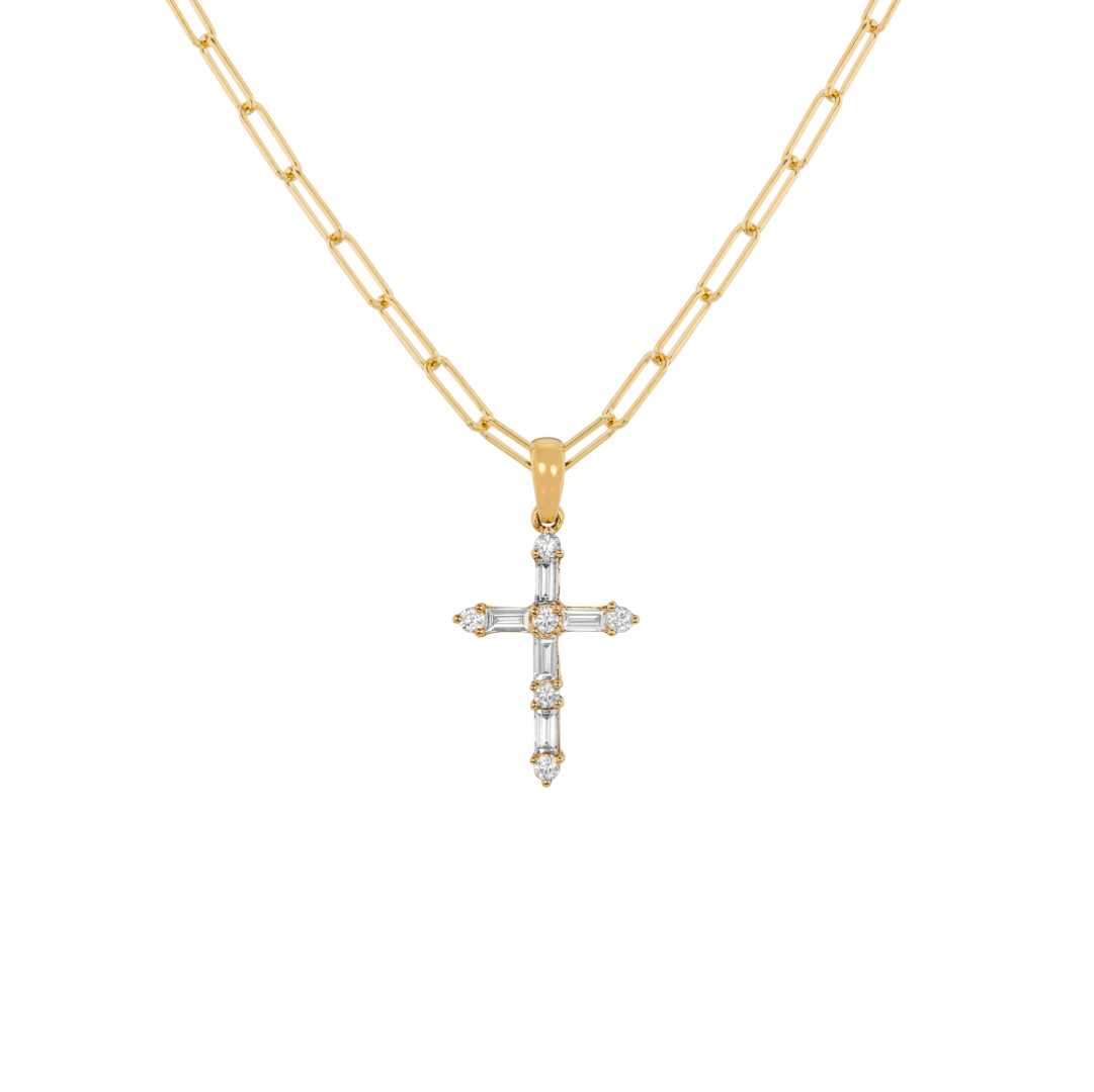 Gold necklace with a baguette cross pendant on white background