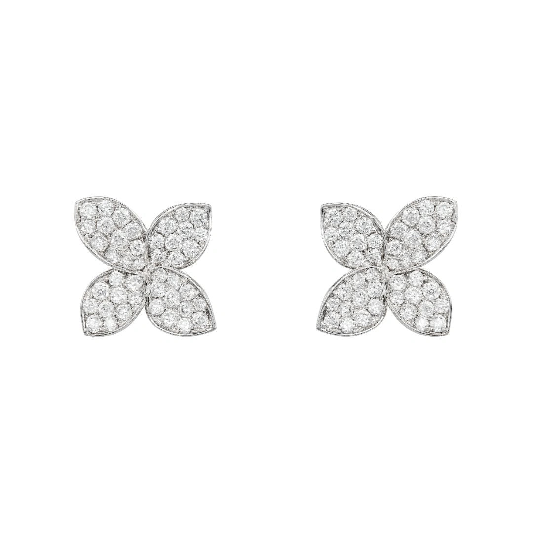 White gold flower petal earrings on white background