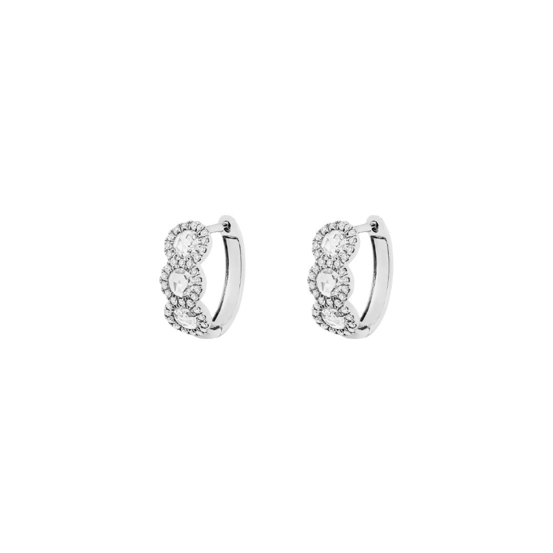 Pair of white gold diamond hoop earrings with clear gemstones on white background