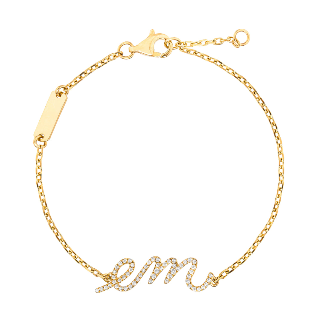 Yellow gold bracelet with 'em' inscription on a white background