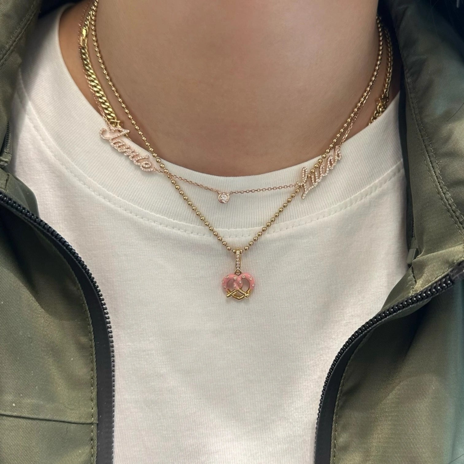 Necklace with a pink pendant worn by a person