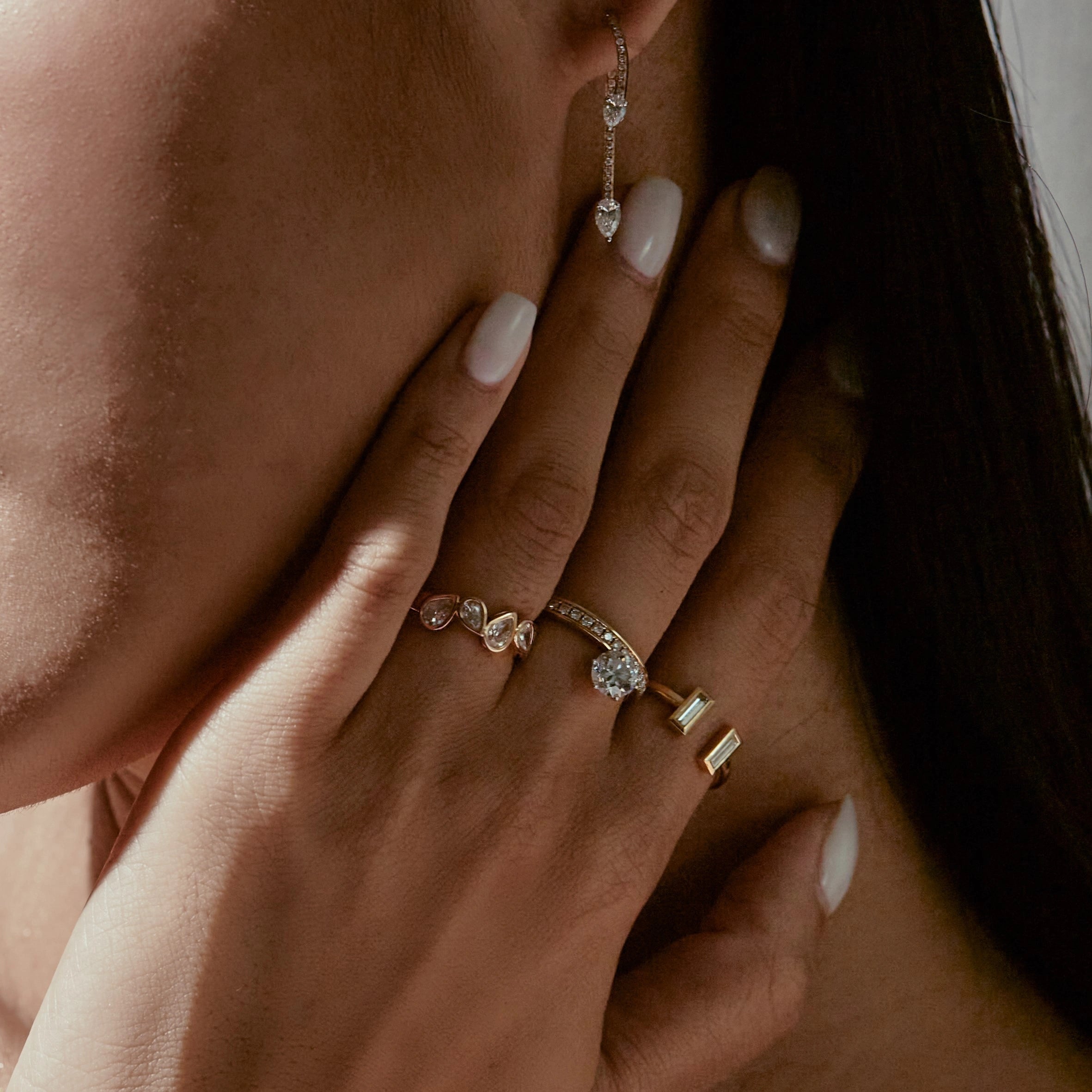 Close-up of a hand wearing multiple diamond rings