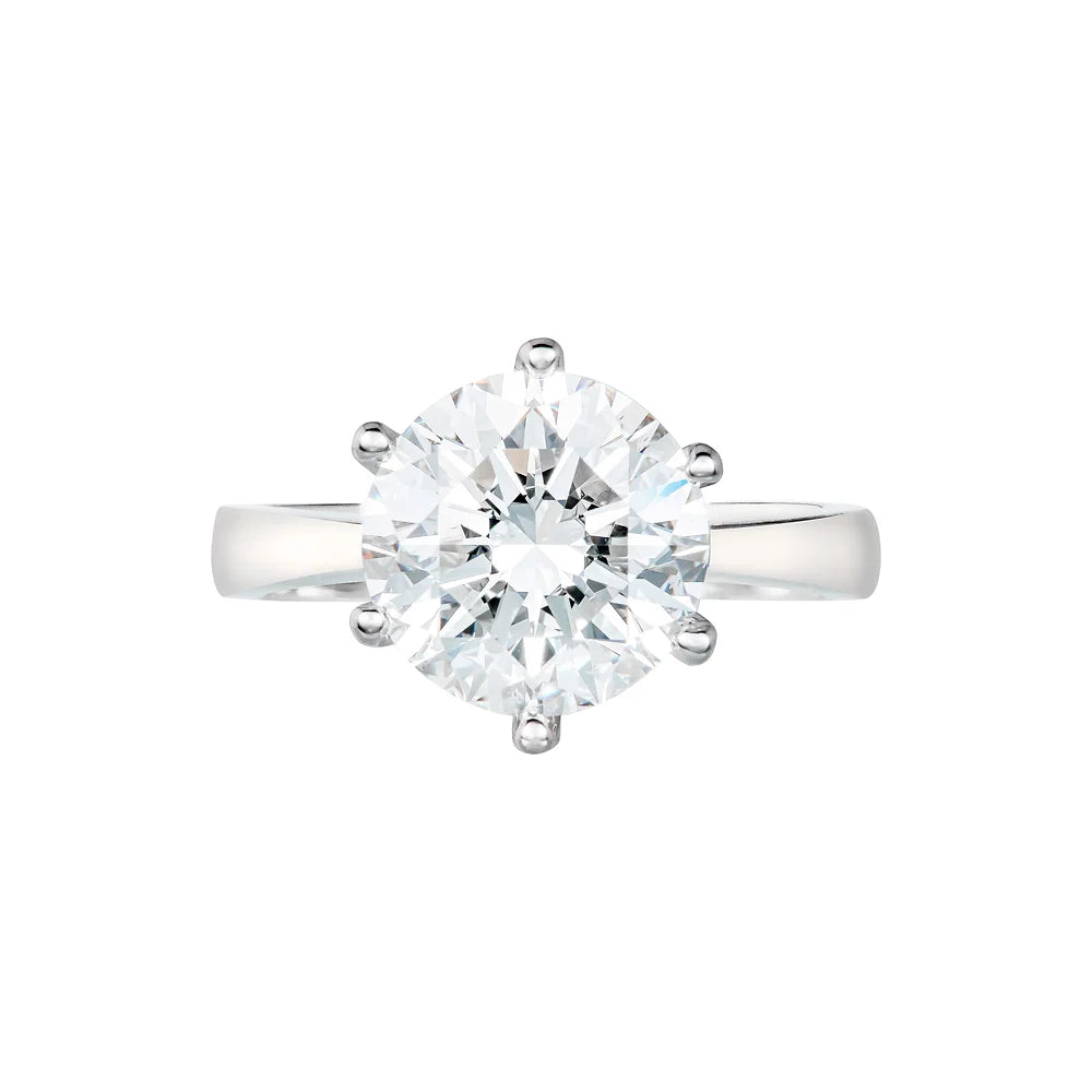 White gold round diamond engagement ring on white background.
