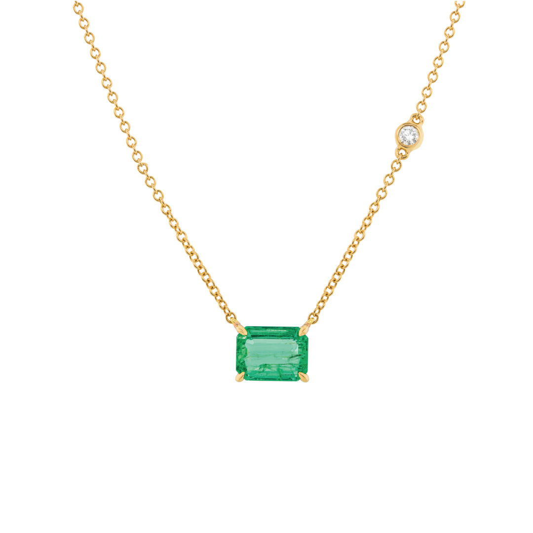 Gold necklace with a Emerald on a white background