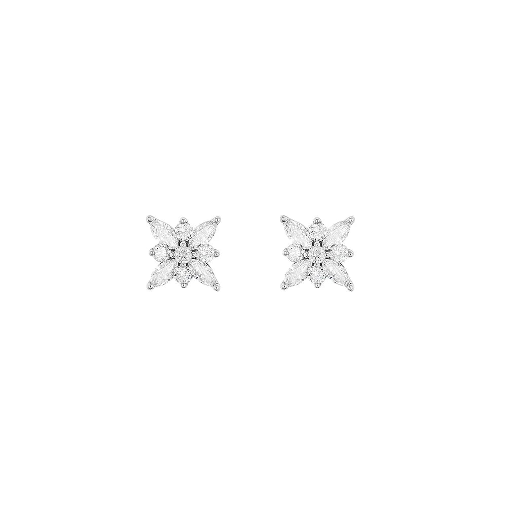 White gold snowflake diamond studs on white background.