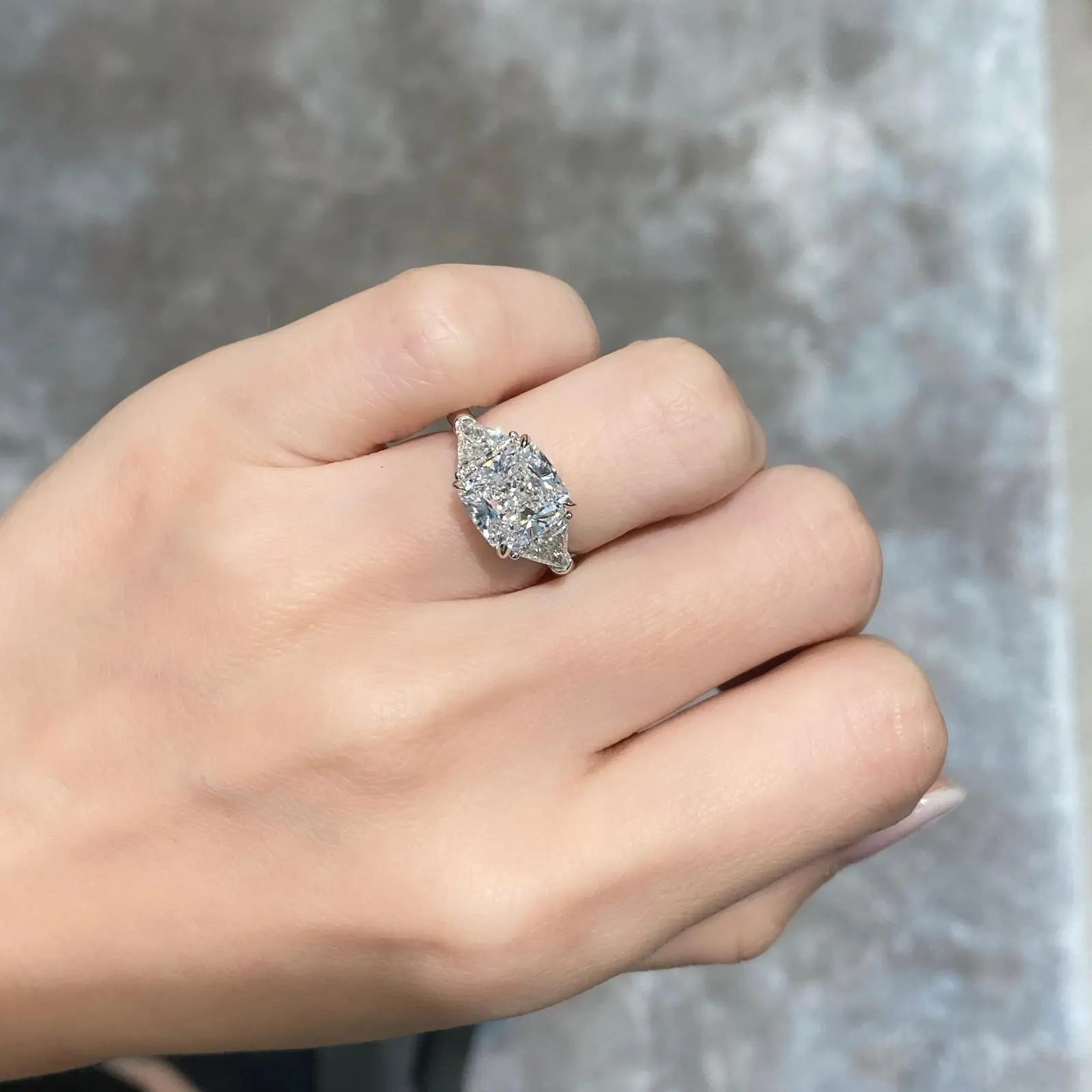 Three stone diamond rings on hand