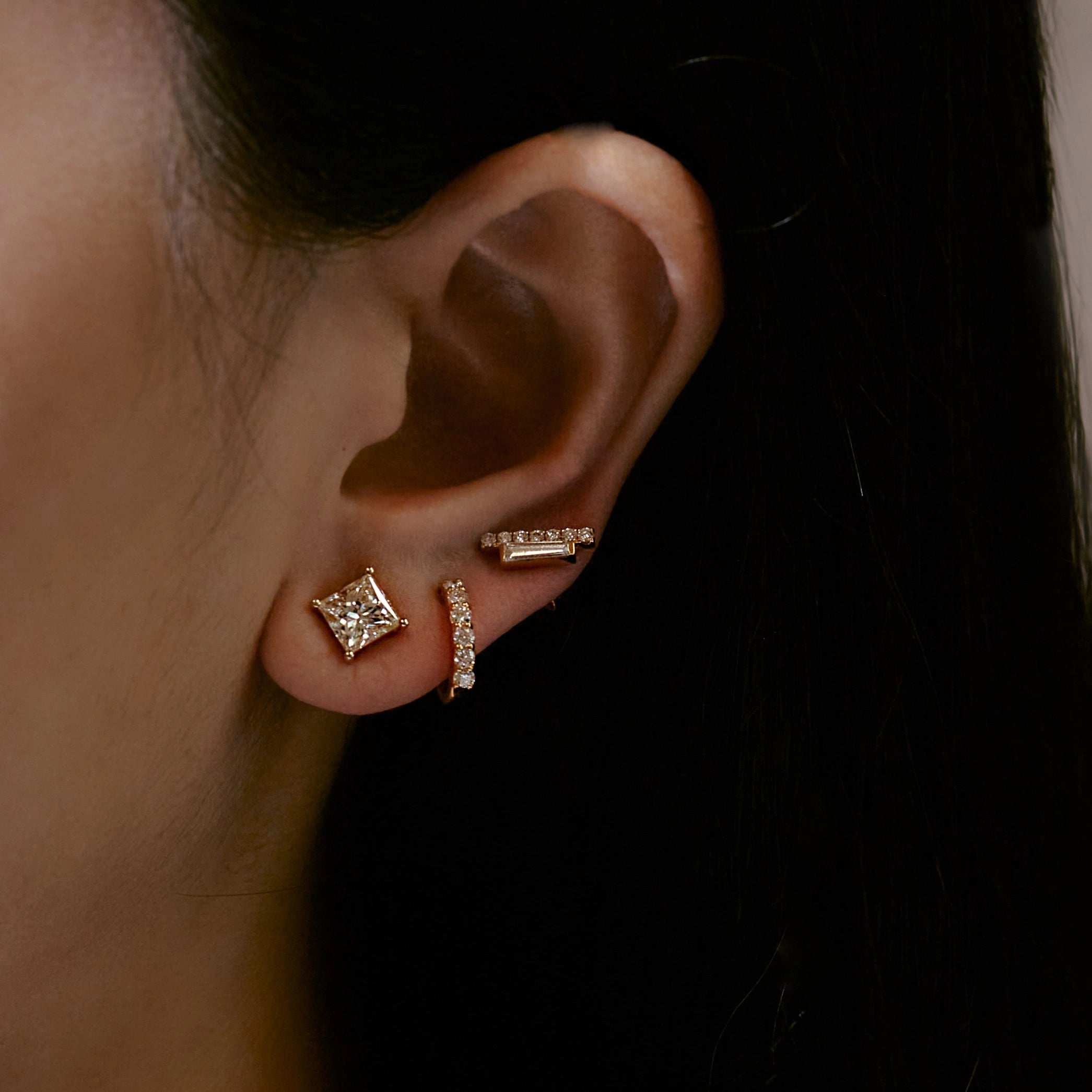 Yellow Gold Diamond Huggies styled with multiple earrings